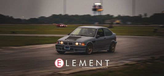BMW E36 doing laps on a closed circuit track.