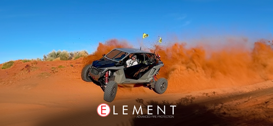 A UTV is zipping through a sandy trail.