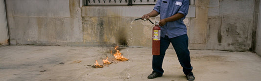 Extinguisher failing to operate due to low pressure while there is an active Class B fire nearby.