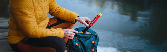 Man pulling out an Element Fire Extinguisher from his emergency go bag.