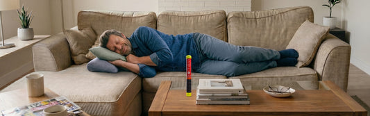 Dad sleeping on the couch with Element Fire Extinguisher sitting on a coffee table. 